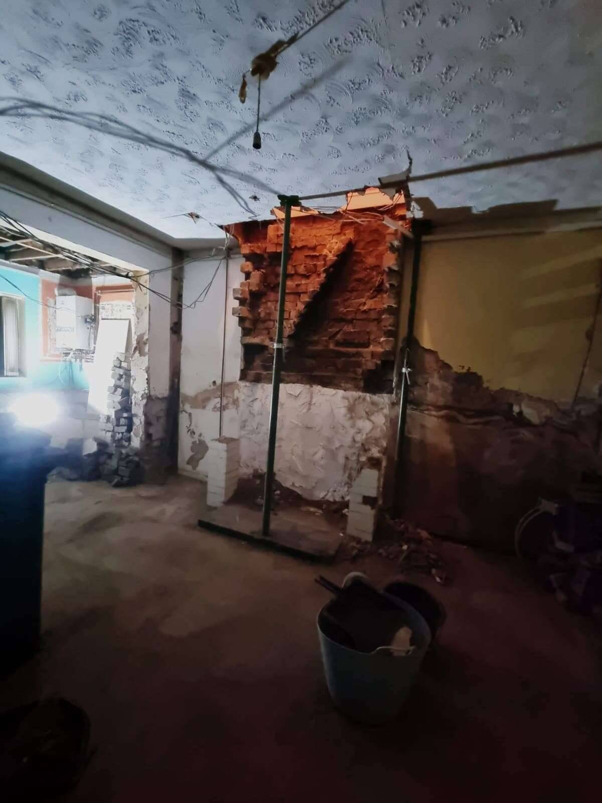 Room stripped back mid-renovation, with steel props supporting the ceiling where an internal wall has been taken out